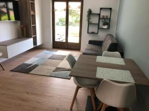 a living room with a table and a couch at Appartamento Piano terra Prestinone Vigezzo LT in Santa Maria Maggiore