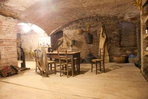 a dining room with a table and chairs in a brick wall at Monferrato Inn in Rivarone