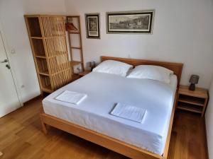 a bedroom with a large white bed with two pillows at Malena Palace Experience in Split