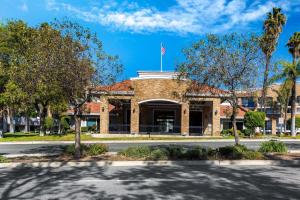 a brick building with an american flag on top at La Quinta by Wyndham Pomona in Pomona