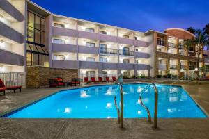 a swimming pool in front of a building at La Quinta by Wyndham Pomona in Pomona