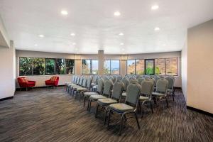 a conference room with chairs and windows at La Quinta by Wyndham Pomona in Pomona