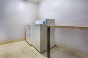 a laundry room with a counter and a refrigerator at La Quinta by Wyndham Pomona in Pomona