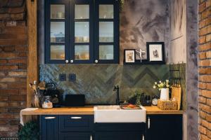 a kitchen with dark blue cabinets and a sink at Apartment Lara in Senj +30 photos