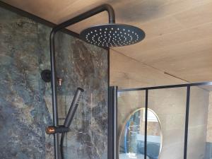 a shower with a black light hanging from a ceiling at fjord : oslo 