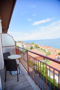 a balcony with a table and a view of the ocean at Panorama Hotel in Muggia