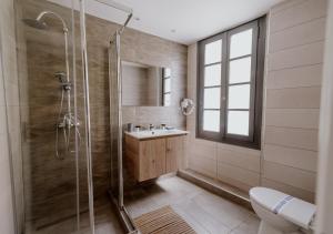 a bathroom with a shower and a sink at ROH Suites in Athens