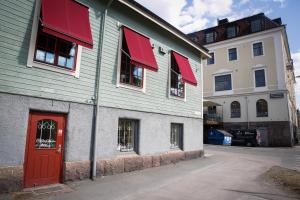 a building with red awnings and a red door at Eksjö Stadshotell in Eksjö