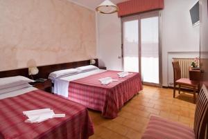Postel nebo postele na pokoji v ubytování Hotel Le Querce