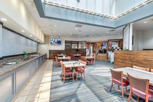 Un restaurante con mesas y sillas y un bar. en SureStay Plus Hotel by Best Western Price, en Price