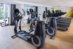 a gym with rows of treadmills and elliptical machines at Courtland Grand Hotel, Trademark Collection by Wyndham former Sheraton Atlanta in Atlanta