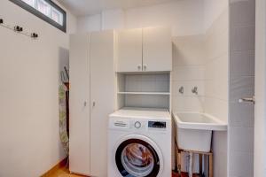 a white laundry room with a washing machine and a sink at Paraiso II EQ FREE WIFI in Playa Paraiso +18 photos