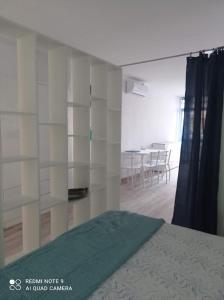 a bedroom with white shelves and a bed in a room at Raquel Apartament in Alicante