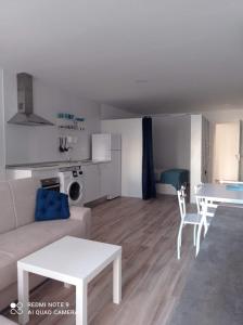 a living room with a couch and a table at Raquel Apartament in Alicante