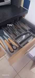 a drawer filled with knives and other kitchen utensils at Studio flat in Leicester
