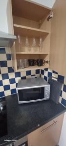 a kitchen with a microwave on a counter at Studio flat in Leicester