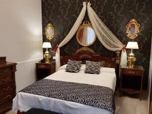 a bedroom with a bed with two zebra pillows at Hotel Europa Boutique Sevilla in Seville