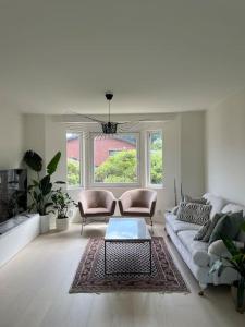 a living room with a couch and two chairs at Villa nära till natur och stan in Gothenburg