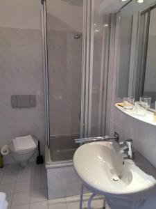 y baño con lavabo, ducha y aseo. en Kleines Logierhaus 03, en Norderney