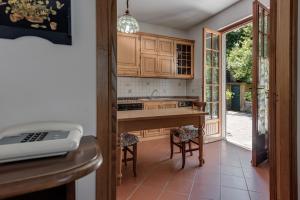 a kitchen with wooden cabinets and a counter top at Gigli di Firenze in Rufina