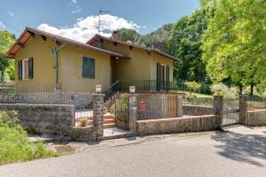 a house with a fence in front of it at Gigli di Firenze in Rufina