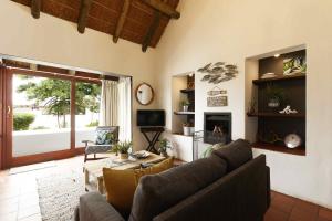 a living room with a couch and a table at River View Cottage - at the Breede - Load-shedding Free in Witsand