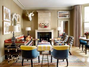 a living room with chairs and a fireplace at Knightsbridge Hotel, Firmdale Hotels in London