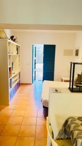 a room with two beds and a table in it at Casa Nena Es Calo in Es Caló