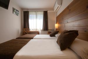 Rúm í herbergi á Hotel Màgic La Massana