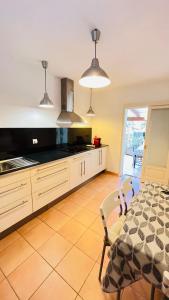 a kitchen with a table and a dining room at Casa Nena Es Calo in Es Caló