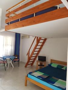 a bedroom with a bunk bed and a staircase at Vila Familija in Dobra Voda