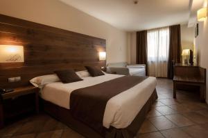 Rúm í herbergi á Hotel Màgic La Massana