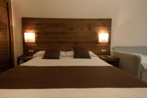 Rúm í herbergi á Hotel Màgic La Massana