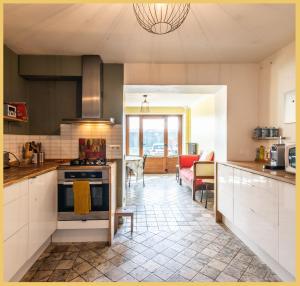 a kitchen with white cabinets and a stove top oven at Maison de village T4 3 chambres avec parking gratuit Monnetier-Mornex in Monnetier-Mornex