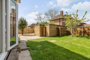 a house with a yard with a fence at 4 bedroom Pitchford in Earlham