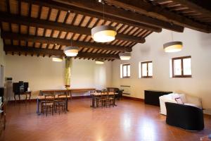a living room with tables and chairs in a building at Agriturismo I Melograni in Ferentillo