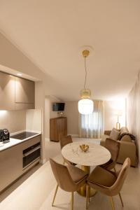 a kitchen and a living room with a table and chairs at Casa Carmela Apartments in Bardolino