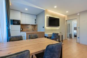 a kitchen and dining room with a wooden table and chairs at Villa Lavanda in Cres