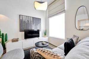 a living room with a couch and a tv at Place du Grand Sablon in Brussels