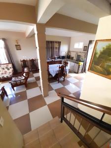 a view of a living room with a checkered floor at Fina Villa Apartments - Mont choisy in Mont Choisy