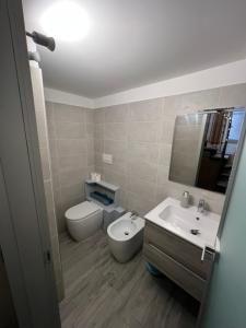 a bathroom with a toilet and a sink at Il Bivacco del Duomo in LʼAquila