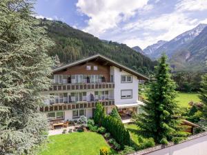 an exterior view of a building with mountains in the background at Garni Zimmerhofer in Campo Tures