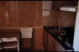 a small kitchen with a sink and a counter at Dolce Appartamento al centro di Civitavecchia in Civitavecchia