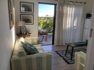 a living room with a couch and a table at The Speckled Egg, 4 Promenade Rd, Lakeside, Cape Town in Cape Town