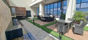 a building with a patio with chairs and tables at LeR Homes in Nairobi