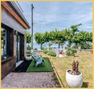 a patio with a bench and a view of the ocean at Appartement Cozy 1 Panoramique Lac Léman Thonon-Les-Bains in Thonon-les-Bains