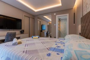 a bedroom with a large bed with a tv on the wall at Villa Lavanda in Cres