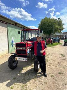 a man standing in front of a tractor at Gästehaus Josef Lang in Andau