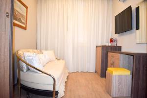 a room with a chair and a tv in a room at Al Dora Residence Suites Hurghada in Hurghada