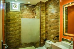 a bathroom with a shower and a toilet and a sink at Al Dora Residence Suites Hurghada in Hurghada